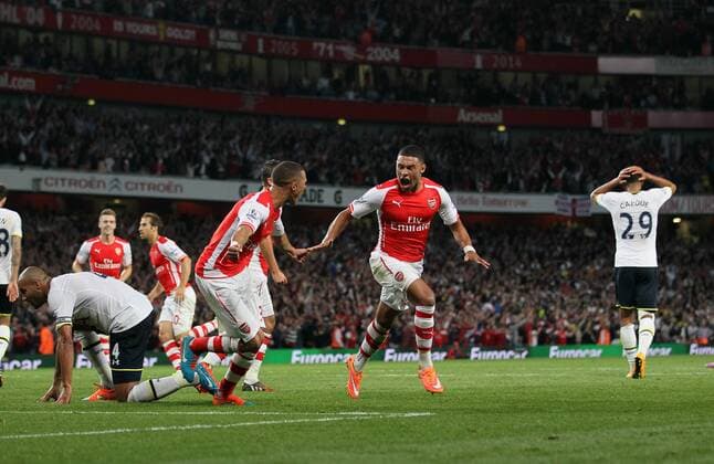 Arsenal s Alex Oxlade-Chamberlain celebrates scoring his sides opening goal - Barclays Premier League - Arsenal vs Tottenham Hotspur - Emirates Stadium - England - 27th September 2014 - EDITORIAL USE ONLY. No use with unauthorised audio, video, data, fixture lists, club league logos or live services. Online in-match use limited to 120 images, no video emulation. No use in betting, games or single club league player publications.