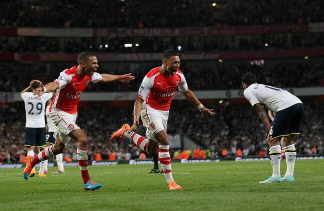 Arsenal s Alex Oxlade-Chamberlain celebrates scoring his sides opening goal - Barclays Premier League - Arsenal vs Tottenham Hotspur - Emirates Stadium - England - 27th September 2014 - EDITORIAL USE ONLY. No use with unauthorised audio, video, data, fixture lists, club league logos or live services. Online in-match use limited to 120 images, no video emulation. No use in betting, games or single club league player publications.