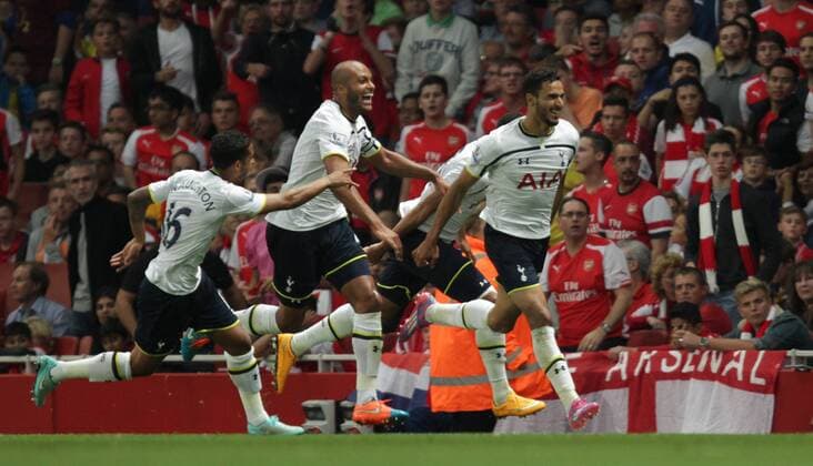 Arsenal FC London - Tottenham Hotspur Nacer Chadli (TH) celebrates scoring a goal for Tottenham, as Younes Kaboul (TH) follows behind. 0-1