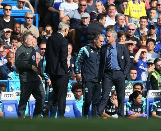 Chelsea s Jose Mourinho and Arsenal s Arsene Wenger square up to each other - Barclays Premier League - Chelsea Fc vs FC Arsenal - Stamford Bridge - England - 5th October 2014 - EDITORIAL USE ONLY. No use with unauthorised audio, video, data, fixture lists, club league logos or live services. Online in-match use limited to 120 images, no video emulation. No use in betting, games or single club league player publications.