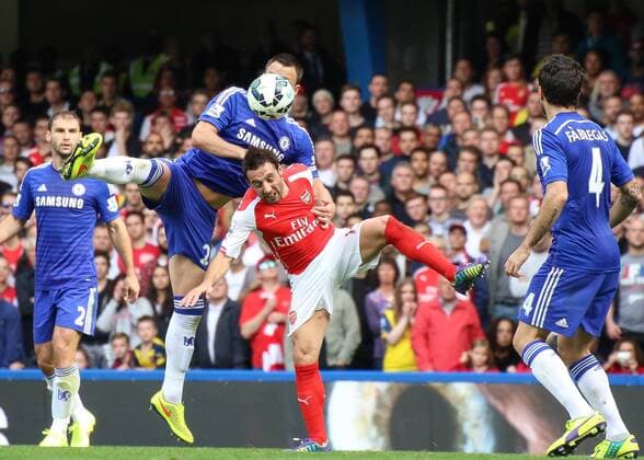 Football - 2014 2015 Premier League - Chelsea vs. Arsenal John Terry of Chelsea FC grapples with Santi Cazorla of Arsenal FC at Stamford Bridge Colorsport Daniel Bearham CHE_ARS
