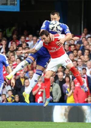 Football - 2014 2015 Premier League - Chelsea vs. Arsenal John Terry of Chelsea FC rises above Santi Cazorla of Arsenal FC at Stamford Bridge Colorsport Daniel Bearham CHE_ARS