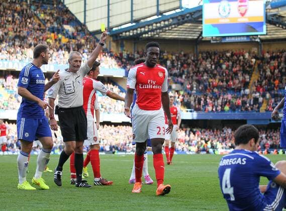 Arsenal s Danny Welbeck goes in with studs up on Chelsea s Cesc Fabregas but is only booked - Barclays Premier League - Chelsea Vs Arsenal - Stamford Bridge - England - 5th October 2014 - EDITORIAL USE ONLY. No use with unauthorised audio, video, data, fixture lists, club league logos or live services. Online in-match use limited to 120 images, no video emulation. No use in betting, games or single club league player publications.