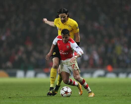 Arsenal s Alexis Sanchez tussles with Dortmund s Neven Subotic UEFA Champions League- Arsenal vs Borussia Dortmund- Emirates Stadium - England - 26th November 2014 - EDITORIAL USE ONLY. No use with unauthorised audio, video, data, fixture lists, club league logos or live services. Online in-match use limited to 120 images, no video emulation. No use in betting, games or single club league player publications.