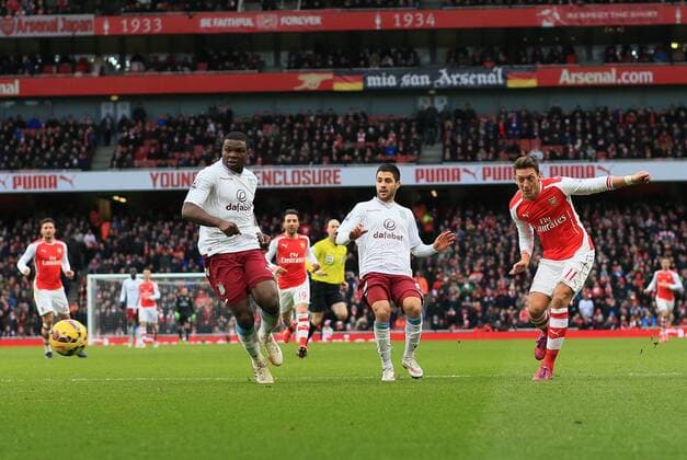 Arsenal s Mesut Ozil scoring his sides second goal Barclays Premier League - Arsenal vs Aston Villa - Emirates Stadium - England - 1st February 2015 - Picture David Klein Sportimage EDITORIAL USE ONLY. No use with unauthorised audio, video, data, fixture lists, club league logos or live services. Online in-match use limited to 120 images, no video emulation. No use in betting, games or single club league player publications.