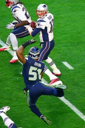 01 FEB 2015: New England Patriots quarterback Tom Brady (12) back to pass gets pressured by Seattle Seahawks outside linebacker Bruce Irvin (51) during the first quarter of Super Bowl XLIX being played at University of Phoenix Stadium. The New England Patriots defeat the Seattle Seahawks 28-24 in Super Bowl XLIX at University of Phoenix Stadium in Glendale Arizona. NFL American Football Herren USA FEB 01 Super Bowl XLIX - Patriots v Seahawks Icon020115327 EDITORIAL USE ONLY