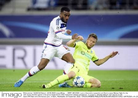 - GENT, BELGIUM: Lyon s Alexandre Lacazette and Gent s Lasse Nielsen fight for the ball during the first game in the group stage of the Uefa Champions League competition, in group H, between Belgian first league soccer team KAA Gent and Olympique Lyon, in Gent, Wednesday 16 September 2015. YORICKxJANSENS x04701510x