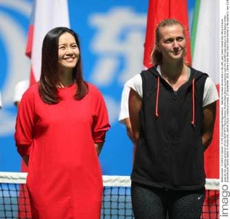 Retired Chinese tennis star Li Na, left, and Czech tennis star Petra Kvitova pose at the opening ceremony of the 2015 WTA Tennis Damen Wuhan Open tennis tournament and the 15,000-seat stadium at the Optics Valley International Tennis Center in Wuhan city, central China s Hubei province, 27 September 2015. China s two-time Grand Slam winner Li Na opened a new 15,000-seat stadium at the Wuhan Open in central China Sunday (27 September 2015) to huge cheers from her hometown fans. The new stadium has been built on the back of Li s career success, she was the first Asian to win a Grand Slam singles, that saw the popularity of tennis surge in China. Huge applause echoed through the stadium as Li, now retired, stepped onto the court wearing a red dress and was joined by the tournament s defending champion Petra Kvitova to open the new stadium officially. Similar in capacity to Wimbledon s centre court, the new stadium is dwarfed only by the US Open s Arthur Ashe stadium which has a capacity of 23,000. It has a retractable roof and a metal and glass structure reminiscent of the iconic bird s nest stadium in Beijing, the centrepiece of the 2008 Olympics. Li Na thrills fans at Wuhan stadium opening 20150927_66314