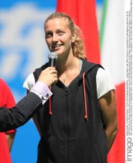 Czech tennis star Petra Kvitova is interviewed at the opening ceremony of the 2015 WTA Tennis Damen Wuhan Open tennis tournament and the 15,000-seat stadium at the Optics Valley International Tennis Center in Wuhan city, central China s Hubei province, 27 September 2015. China s two-time Grand Slam winner Li Na opened a new 15,000-seat stadium at the Wuhan Open in central China Sunday (27 September 2015) to huge cheers from her hometown fans. The new stadium has been built on the back of Li s career success, she was the first Asian to win a Grand Slam singles, that saw the popularity of tennis surge in China. Huge applause echoed through the stadium as Li, now retired, stepped onto the court wearing a red dress and was joined by the tournament s defending champion Petra Kvitova to open the new stadium officially. Similar in capacity to Wimbledon s centre court, the new stadium is dwarfed only by the US Open s Arthur Ashe stadium which has a capacity of 23,000. It has a retractable roof and a metal and glass structure reminiscent of the iconic bird s nest stadium in Beijing, the centrepiece of the 2008 Olympics. Li Na thrills fans at Wuhan stadium opening 20150927_66317