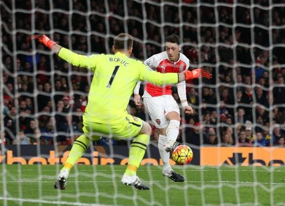 Arsenal s Mesut Ozil scoring his sides second goal Barclays Premier League- Arsenal vs AFC Bournemouth - Emirates Stadium - England - 28th December 2015 - Picture - David Klein Sportimage EDITORIAL USE ONLY. No use with unauthorised audio, video, data, fixture lists, club league logos or live services. Online in-match use limited to 120 images, no video emulation. No use in betting, games or single club league player publications.