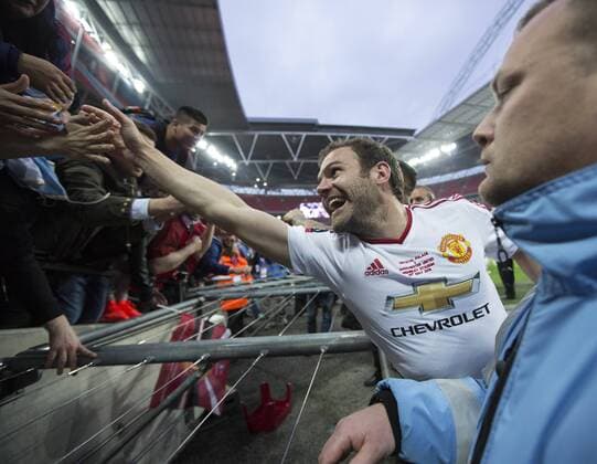 Manchester United ManU s Juan Mata celebrates with the fans during the Emirates FA Cup Final match at Wembley Stadium. Photo credit should read: David Klein Sportimage EDITORIAL USE ONLY. No use with unauthorised audio, video, data, fixture lists, club league logos or live services. Online in-match use limited to 120 images, no video emulation. No use in betting, games or single club league player publications.