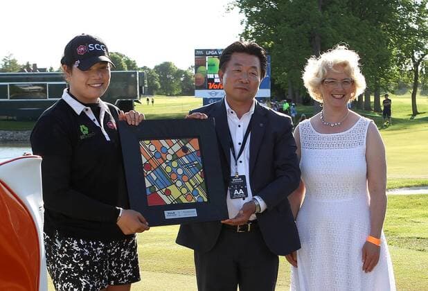 May 29, 2016 - Ann Arbor, Michigan, United States - Ariya Jutanugarn of Bangkok, and Kyung Ahn Moon, Chairman of Volvik INC and world-renowned local artist Nawal Matowi, designer of the trophy, pose for a photo after winning the final round of the inaugural LPGA Golf Damen Volvik Championship at Travis Pointe Country Club in Ann Arbor, MI, USA Sunday, May 29, 2016. LPGA Volvik Championship - Final Round - ZUMAn230