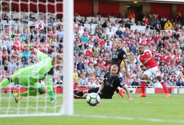 Arsenal s Theo Walcott scoring his sides opening goal during the Premier League match at the Emirates Stadium, London. Picture date August 14th, 2016 Pic David Klein Sportimage EDITORIAL USE ONLY. No use with unauthorised audio, video, data, fixture lists, club league logos or live services. Online in-match use limited to 120 images, no video emulation. No use in betting, games or single club league player publications.