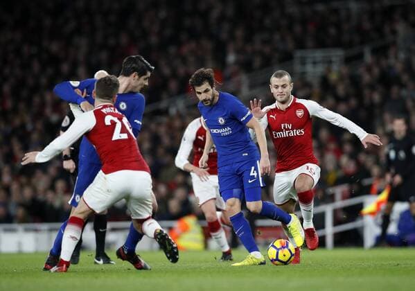 Chelsea s Cesc Fabregas tussles with Arsenal?s Jack Wilshere during the premier league match at the Emirates Stadium, London. Picture date 3rd January 2018. Picture credit should read: David Klein Sportimage EDITORIAL USE ONLY. No use with unauthorised audio, video, data, fixture lists, club league logos or live services. Online in-match use limited to 120 images, no video emulation. No use in betting, games or single club league player publications.