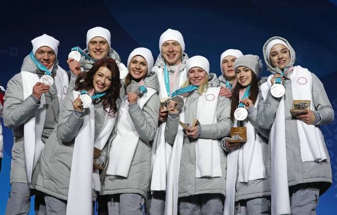 PYEONGCHANG, SOUTH KOREA – FEBRUARY 12, 2018: Olympic Athletes from Russia Dmitri Soloviev, Alexander Enbert, Ekaterina Bobrova, Natalya Zabiyako, Vladimir Morozov, Yevgenia Tarasova, Mikhail Kolyada, Alina Zagitova, and Evgenia Medvedeva, from left, pose with their silver medals during the victory ceremony for the Figure skating Eiskunstlauf team event at the 2018 Winter Olympic Games Olympische Spiele Olympia OS Valery Sharifulin TASS TS0737C2