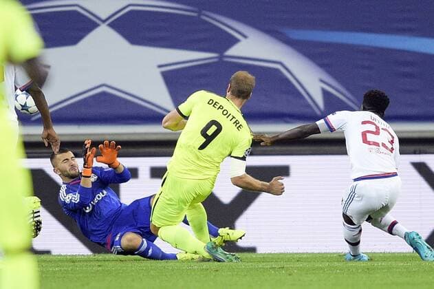 - GENT, BELGIUM: Lyon s goalkeeper Anthony Lopes, Gent s Laurent Depoitre and Lyon s Samuel Umtiti fight for the ball during the first game in the group stage of the Uefa Champions League competition, in group H, between Belgian first league soccer team KAA Gent and Olympique Lyon, in Gent, Wednesday 16 September 2015. YORICKxJANSENS x85279455x