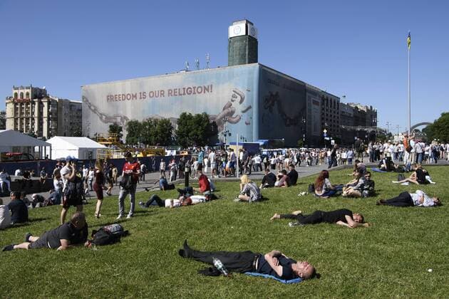 Fußball, CL-Finale, Fans vor dem Spiel May 26, 2018 - Kiev, Ukraine - Soccer fans lay on the grass as waiting for the kick-off at the Maidan Square, near the fan zone, in doiwntown Kyiv, Ukraine, prior to the UEFA Champions League Final between Real Madrid and Liverpool at NSC Olimpiyskiy Stadium on May 26, 2018 in Kiev, Ukraine. Real Madrid v Liverpool - UEFA Champions League Final Previews - ZUMAn230 20180526_zaa_n230_794 Copyright: xMaxymxMarusenkox