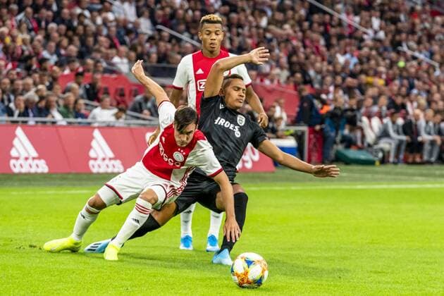 AMSTERDAM, Netherlands, 13-08-2019, football, Johan Cruijff ArenA, Champions League third qualifying round, season 2019-2020, Ajax player Nico Tagliafico (L), PAOK Saloniki player Leo Jaba (R), during the match Ajax - PAOK, Ajax - PAOK x4105189x Copyright: