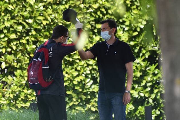 (200506) -- BOLOGNA, May 6, 2020 (Xinhua) -- A staff member measures the body temperature of Bologna s Riccardo Orsolini (L) before the training session in Bologna, Italy, May 5, 2020. According to the plan, from May 4, Serie A football clubs can arrange players for individual training or group training, and from the May 18, each team can resume group training and prepare for Serie A rematch. During this period, each club will strictly abide by the epidemic prevention regulations, such as conducting Covid-19 tests on schedule. (Photo by Gianni Schicchi Xinhua) (SP)ITALY-BOLOGNA-FOOTBALL-SERIE A-BOLOGNA-TRAINING