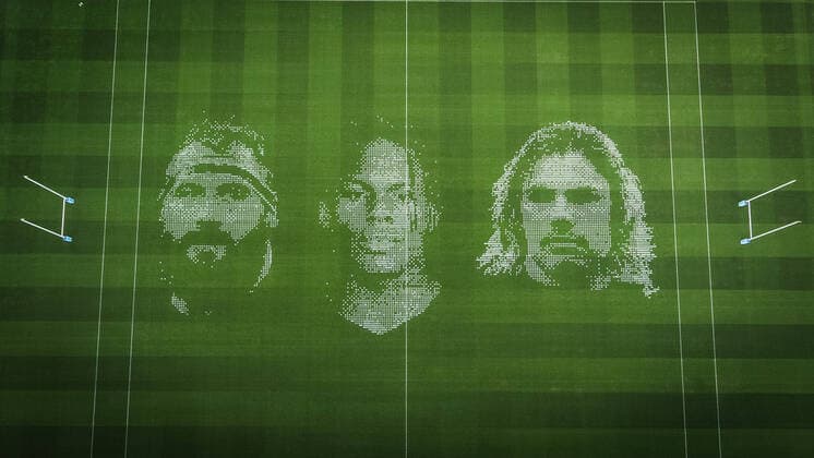 The pitch at Twickenham Stadium has been transformed into a stunning portrait featuring three of Premiership Rugby?s star players today (12th August 2020). The giant rugby art, the largest outdoor painting ever created in the UK, was unveiled to celebrate the restart of Gallagher Premiership Rugby on Friday 14 th August when Harlequins take on Sale Sharks at 7:45pm, just 200 metres away. The artwork features Harlequins player, Joe Marler; Saracens? Maro Itoje, as well as Sale Sharks? Rugby World Cup winner Faf de Klerk. It took team of eight artists more than 24 hours to complete the pitch portrait and more than 100 hours of planning before any paint touched the grass. A bespoke computer program was written to generate the precise measurements that were needed to create the artwork to the exact scale of the stadium. The image, which occupies most of the 7,000 square metre pitch, was created using a grid comprised of 13,420 elements. Each painted line in the portrait is just 6 inches wide. Nearly 1280 litres of biodegradable pitch marker paint were used for the elaborate creation. An estimated 150,000 passengers will enjoy the spectacle from the sky this week on flights in and out of London?s Heathrow airport. Faf de Klerk was one of the featured Premiership Rugby stars in the portrait. The Sale Sharks star said, I didn t realise it was going to be on the field, I thought it was going to be a photo up somewhere or on the big screen. It s looking really cool. There are a lot of great players in the Premiership, and it is amazing. I feel really privileged and quite humble . Speaking about the impact of lockdown on the Saracens star Maro Itoje said The last few months have been really tough on fans and players but we?re back and we?re ready for the start of the season on Friday 14th August. The past five months has shown us how important the sport is and what it brings to people lives. British artist John Lundberg, who oversaw the po Copyright: xScottxGarfitt PinPep CoverxImagesx 0103040120st EDITORIAL USE ONLY. RESTRICTED TO NEWSPAPERS BASED IN THE UK