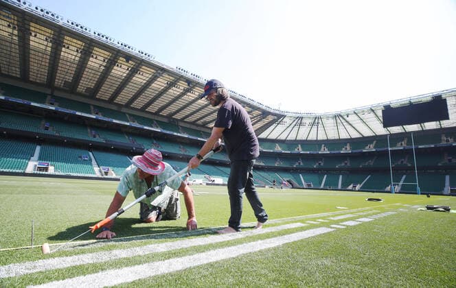 The pitch at Twickenham Stadium has been transformed into a stunning portrait featuring three of Premiership Rugby?s star players today (12th August 2020). The giant rugby art, the largest outdoor painting ever created in the UK, was unveiled to celebrate the restart of Gallagher Premiership Rugby on Friday 14 th August when Harlequins take on Sale Sharks at 7:45pm, just 200 metres away. The artwork features Harlequins player, Joe Marler; Saracens? Maro Itoje, as well as Sale Sharks? Rugby World Cup winner Faf de Klerk. It took team of eight artists more than 24 hours to complete the pitch portrait and more than 100 hours of planning before any paint touched the grass. A bespoke computer program was written to generate the precise measurements that were needed to create the artwork to the exact scale of the stadium. The image, which occupies most of the 7,000 square metre pitch, was created using a grid comprised of 13,420 elements. Each painted line in the portrait is just 6 inches wide. Nearly 1280 litres of biodegradable pitch marker paint were used for the elaborate creation. An estimated 150,000 passengers will enjoy the spectacle from the sky this week on flights in and out of London?s Heathrow airport. Faf de Klerk was one of the featured Premiership Rugby stars in the portrait. The Sale Sharks star said, I didn t realise it was going to be on the field, I thought it was going to be a photo up somewhere or on the big screen. It s looking really cool. There are a lot of great players in the Premiership, and it is amazing. I feel really privileged and quite humble . Speaking about the impact of lockdown on the Saracens star Maro Itoje said The last few months have been really tough on fans and players but we?re back and we?re ready for the start of the season on Friday 14th August. The past five months has shown us how important the sport is and what it brings to people lives. British artist John Lundberg, who oversaw the po Copyright: xScottxGarfitt PinPep CoverxImagesx 0103040130st EDITORIAL USE ONLY. RESTRICTED TO NEWSPAPERS BASED IN THE UK