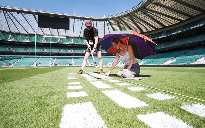 The pitch at Twickenham Stadium has been transformed into a stunning portrait featuring three of Premiership Rugby?s star players today (12th August 2020). The giant rugby art, the largest outdoor painting ever created in the UK, was unveiled to celebrate the restart of Gallagher Premiership Rugby on Friday 14 th August when Harlequins take on Sale Sharks at 7:45pm, just 200 metres away. The artwork features Harlequins player, Joe Marler; Saracens? Maro Itoje, as well as Sale Sharks? Rugby World Cup winner Faf de Klerk. It took team of eight artists more than 24 hours to complete the pitch portrait and more than 100 hours of planning before any paint touched the grass. A bespoke computer program was written to generate the precise measurements that were needed to create the artwork to the exact scale of the stadium. The image, which occupies most of the 7,000 square metre pitch, was created using a grid comprised of 13,420 elements. Each painted line in the portrait is just 6 inches wide. Nearly 1280 litres of biodegradable pitch marker paint were used for the elaborate creation. An estimated 150,000 passengers will enjoy the spectacle from the sky this week on flights in and out of London?s Heathrow airport. Faf de Klerk was one of the featured Premiership Rugby stars in the portrait. The Sale Sharks star said, I didn t realise it was going to be on the field, I thought it was going to be a photo up somewhere or on the big screen. It s looking really cool. There are a lot of great players in the Premiership, and it is amazing. I feel really privileged and quite humble . Speaking about the impact of lockdown on the Saracens star Maro Itoje said The last few months have been really tough on fans and players but we?re back and we?re ready for the start of the season on Friday 14th August. The past five months has shown us how important the sport is and what it brings to people lives. British artist John Lundberg, who oversaw the po Copyright: xScottxGarfitt PinPep CoverxImagesx 0103040133st EDITORIAL USE ONLY. RESTRICTED TO NEWSPAPERS BASED IN THE UK