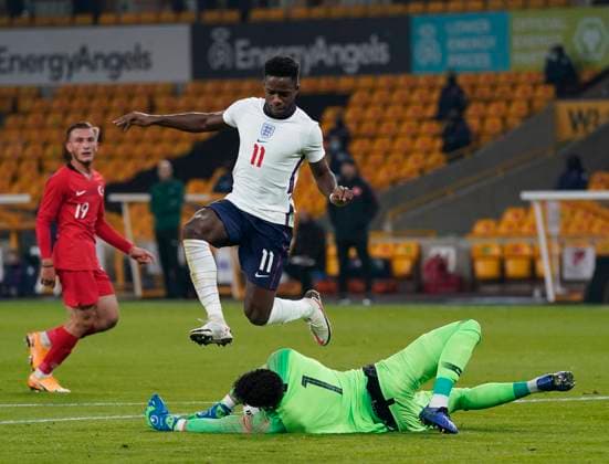 Altay Bayindir of Turkey saves at the feet of Ryan Sessegnon of England during the UEFA EURO, EM, Europameisterschaft,Fussball U21, U 21 Qualifying match at Molineux, Wolverhampton. Picture date: 13th October 2020. Picture credit should read: Andrew Yates Sportimage EDITORIAL USE ONLY. No use with unauthorised audio, video, data, fixture lists, club league logos or live services. Online in-match use limited to 120 images, no video emulation. No use in betting, games or single club league player publications. SPI-0696-0013
