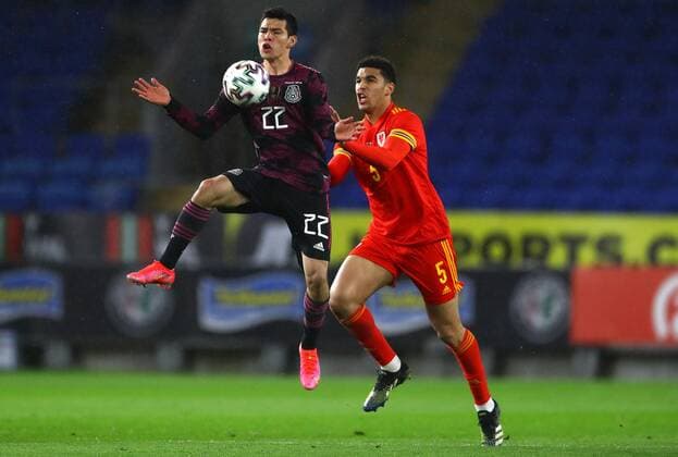 Mandatory Credit: Photo by Kieran McManus BPI Shutterstock (11832375h) Hirving Lozano of Mexico and Ben Cabango of Wales in action Wales v Mexico, International Friendly, Länderspiel, Nationalmannschaft Football, The Cardiff City Stadium, Cardiff, UK - 27 Mar 2021 EDITORIAL USE ONLY No use with unauthorised audio, video, data, fixture lists, club league logos or live services. Online in-match use limited to 120 images, no video emulation. No use in betting, games or single club league player publications. Wales v Mexico, International Friendly, Football, The Cardiff City Stadium, Cardiff, UK - 27 Mar 2021 EDITORIAL USE ONLY No use with unauthorised audio, video, data, fixture lists, club league logos or live services. Online in-match use limited to 120 images, no video emulation. No use in betting, games or single club league player publications. Copyright: xKieranxMcManus BPI Shutterstockx 11832375h