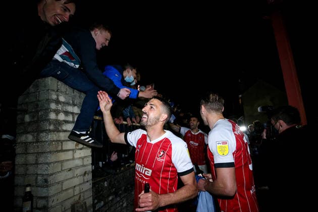 Mandatory Credit: Photo by Robbie Stephenson JMP Shutterstock (11878432cl) Cheltenham Town celebrate promotion out of Sky Bet League Two into Sky Bet League One with fans Cheltenham Town v Carlisle United, UK - 27 Apr 2021 EDITORIAL USE ONLY No use with unauthorised audio, video, data, fixture lists (outside the EU), club league logos or live services. Online in-match use limited to 45 images (+15 in extra time). No use to emulate moving images. No use in betting, games or single club league player publications services. Cheltenham Town v Carlisle United, UK - 27 Apr 2021 EDITORIAL USE ONLY No use with unauthorised audio, video, data, fixture lists (outside the EU), club league logos or live services. Online in-match use limited to 45 images (+15 in extra time). No use to emulate moving images. No use in betting, games or Copyright: xRobbiexStephenson JMP Shutterstockx 11878432cl