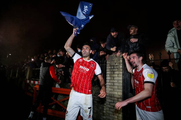 Mandatory Credit: Photo by Robbie Stephenson JMP Shutterstock (11878432cf) Cheltenham Town celebrate promotion out of Sky Bet League Two into Sky Bet League One with fans Cheltenham Town v Carlisle United, UK - 27 Apr 2021 EDITORIAL USE ONLY No use with unauthorised audio, video, data, fixture lists (outside the EU), club league logos or live services. Online in-match use limited to 45 images (+15 in extra time). No use to emulate moving images. No use in betting, games or single club league player publications services. Cheltenham Town v Carlisle United, UK - 27 Apr 2021 EDITORIAL USE ONLY No use with unauthorised audio, video, data, fixture lists (outside the EU), club league logos or live services. Online in-match use limited to 45 images (+15 in extra time). No use to emulate moving images. No use in betting, games or Copyright: xRobbiexStephenson JMP Shutterstockx 11878432cf