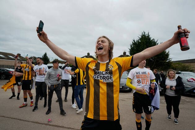 Mandatory Credit: Photo by Joe Toth BPI Shutterstock (11893216fl) Declan Drysdale of Cambridge United (6) celebrates winning promotion to EFL Sky Bet League One in the parking lot of The Abbey Stadium where fans have congregated outside Cambridge United v Grimsby Town, EFL Sky Bet League Two, Football, The Abbey Stadium, Cambridge, UK - 08 May 2021 EDITORIAL USE ONLY No use with unauthorised audio, video, data, fixture lists, club league logos or live services. Online in-match use limited to 120 images, no video emulation. No use in betting, games or single club league player publications. Cambridge United v Grimsby Town, EFL Sky Bet League Two, Football, The Abbey Stadium, Cambridge, UK - 08 May 2021 EDITORIAL USE ONLY No use with unauthorised audio, video, data, fixture lists, club league logos or live services. Online in-match use limited to 120 images, no video emulation. No use in betting, games or single club league player publications. Copyright: xJoexToth BPI Shutterstockx 11893216fl