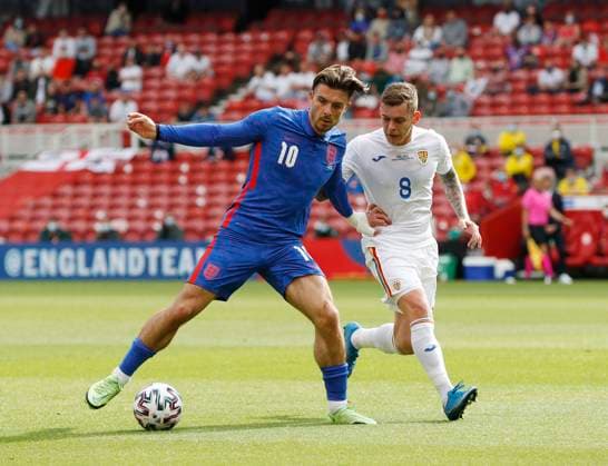 Middlesbrough, England, 6th June 2021. Jack Grealish of England holds off Alexandru Cicaldau of Romania during the International Friendly, Länderspiel, Nationalmannschaft match at the Riverside Stadium, Middlesbrough. Picture credit should read: Darren Staples Sportimage EDITORIAL USE ONLY. No use with unauthorised audio, video, data, fixture lists, club league logos or live services. Online in-match use limited to 120 images, no video emulation. No use in betting, games or single club league player publications. SPI-1079-0024
