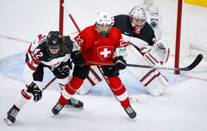 August 24, 2021, Calgary, ab, Canada: Switzerland s Sinja Leemann, centre, holds her position while being is checked by Canada s Claire Thompson in front of goalie Emerance Maschmeyer during second period IIHF Women s World Championship, WM, Weltmeisterschaft hockey action in Calgary, Tuesday, Aug. 24, 2021. Emerance Maschmeyer, Claire Thompson, Sinja Leemann - ZUMAc35_ 20210824_zaf_c35_088 Copyright: xJeffxMcintoshx
