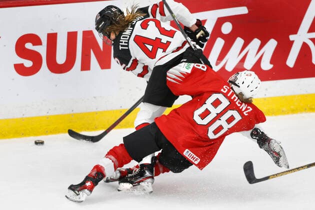 Canada player Claire Thompson, top, wins the puck battle over Switzerland player Phoebe Staenz, bott, during IIHF Women s World Championship, WM, Weltmeisterschaft play in Calgary, Alberta, Canada on Aug. 24, 2021. digital photo by Larry MacDougal Claire Thompson, Phoebe Staenz