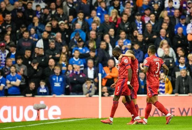 Mandatory Credit: Photo by Stuart Wallace Shutterstock (12447004y) Karl Toko Ekambi of Olympique Lyon celebrates with team mates Maxence Caqueret & Emerson Palmieri of Olympique Lyon after scoring to give Lyon a 0-1 lead. Rangers v Olympique Lyonnais, UEFA Europa League, Group A, Football, Ibrox Stadium, Glasgow, UK - 16 Sep 2021 EDITORIAL USE ONLY No use with unauthorised audio, video, data, fixture lists, club league logos or live services. Online in-match use limited to 120 images, no video emulation. No use in betting, games or single club league player publications. Rangers v Olympique Lyonnais, UEFA Europa League, Group A, Football, Ibrox Stadium, Glasgow, UK - 16 Sep 2021 EDITORIAL USE ONLY No use with unauthorised audio, video, data, fixture lists, club league logos or live services. Online in-match use limited to 120 images, no video emulation. No use in betting, games or single club league player publications. Copyright: xStuartxWallace Shutterstockx 12447004y