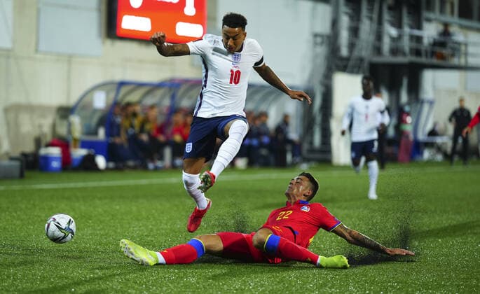 Mandatory Credit: Photo by Javier Garcia Shutterstock (12530028ac) CAPTION CORRECTION - Rubber pellets fly up as Christian Garcia of Andorra tackles Jesse Lingard of England and subsequently injures himself Andorra v England, FIFA World Cup, WM, Weltmeisterschaft, Fussball 2022 Qualifying, Group I, Football, Estadi Nacional, Andorra la Vella, Andorra - 09 Oct 2021 EDITORIAL USE ONLY No use with unauthorised audio, video, data, fixture lists, club league logos or live services. Online in-match use limited to 120 images, no video emulation. No use in betting, games or single club league player publications. Andorra v England, FIFA World Cup 2022 Qualifying, Group I, Football, Estadi Nacional, Andorra la Vella, Andorra - 09 Oct 2021 EDITORIAL USE ONLY No use with unauthorised audio, video, data, fixture lists, club league logos or live services. Online in-match use limited to 120 images, no video emulation. No use in betting, games or single club league player publications. Copyright: xJavierxGarcia Shutterstockx 12530028ac