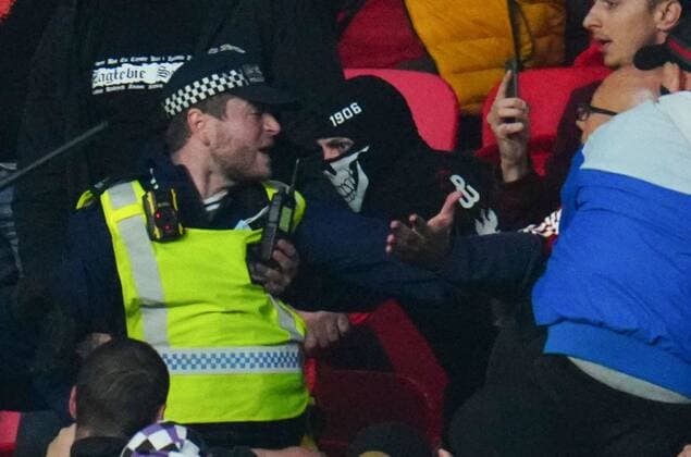 Mandatory Credit: Photo by Javier Garcia Shutterstock (12534018es) A Hungary fan tries to grab the radio of a police officer during clashes in the stands England v Hungary, FIFA World Cup, WM, Weltmeisterschaft, Fussball 2022 Qualifying, Group I, Football, Wembley Stadium, London, UK - 12 Oct 2021 EDITORIAL USE ONLY No use with unauthorised audio, video, data, fixture lists, club league logos or live services. Online in-match use limited to 120 images, no video emulation. No use in betting, games or single club league player publications. England v Hungary, FIFA World Cup 2022 Qualifying, Group I, Football, Wembley Stadium, London, UK - 12 Oct 2021 EDITORIAL USE ONLY No use with unauthorised audio, video, data, fixture lists, club league logos or live services. Online in-match use limited to 120 images, no video emulation. No use in betting, games or single club league player publications. Copyright: xJavierxGarcia Shutterstockx 12534018es
