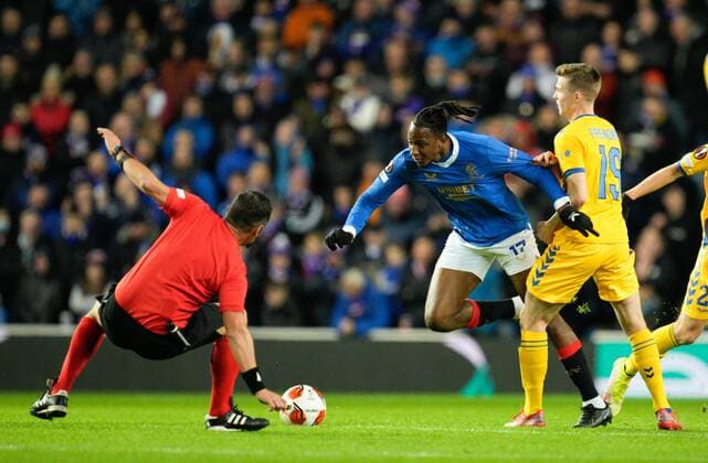 Mandatory Credit: Photo by Stuart Wallace Shutterstock (12547363ao) Referee Fran Jovic falls in front of Joe Aribo of Rangers as Aribo beats Morten Frendrup of Brondby. Rangers v Brondby, UEFA Europa League, Group A, Football, Ibrox Stadium, Glasgow, UK - 21 Oct 2021 EDITORIAL USE ONLY No use with unauthorised audio, video, data, fixture lists, club league logos or live services. Online in-match use limited to 120 images, no video emulation. No use in betting, games or single club league player publications. Rangers v Brondby, UEFA Europa League, Group A, Football, Ibrox Stadium, Glasgow, UK - 21 Oct 2021 EDITORIAL USE ONLY No use with unauthorised audio, video, data, fixture lists, club league logos or live services. Online in-match use limited to 120 images, no video emulation. No use in betting, games or single club league player publications. Copyright: xStuartxWallace Shutterstockx 12547363ao