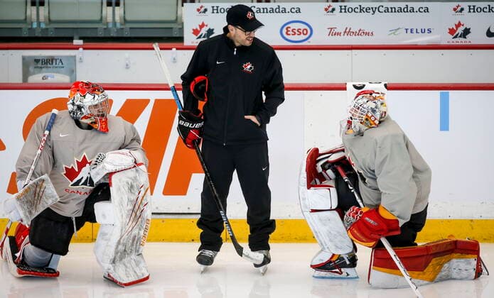 December 11, 2021, Calgary, AB, CANADA: Goaltending coach Olivier Michaud, centre, gives instruction to unidentifeid practice goalies during a practice at the Canadian World Junior Hockey Championships selection camp in Calgary, Alta., Saturday, Dec. 11, 2021. Olivier Michaud - ZUMAc35_ 20211211_zaf_c35_032 Copyright: xJeffxMcintoshx