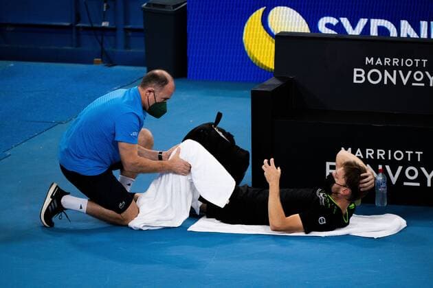 Mandatory Credit: Photo by Shutterstock (12757785v) David Goffin receiving medical treatment during his Quarter Final Match Sydney Tennis Classic, Day 5, Tennis, Olympic Park, Sydney, Australia - 13 Jan 2022 Sydney Tennis Classic, Day 5, Tennis, Olympic Park, Sydney, Australia - 13 Jan 2022 Copyright: xShutterstockx 12757785v
