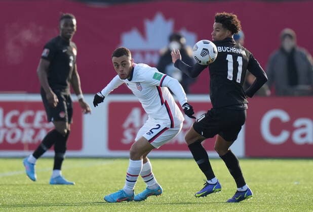 January 30, 2022, Hamilton, ON, CANADA: USA s Sergino Dest, centre, and Canada s Tajon Buchanan, right, battle for the ball during men s first half World Cup Qualifier at sold out Tim Hortons Field in Hamilton, Ontario on Sunday Jan. 30, 2022. Canada News - January 30, 2022 - ZUMAc35_ 20220130_zaf_c35_057 Copyright: xNathanxDenettex