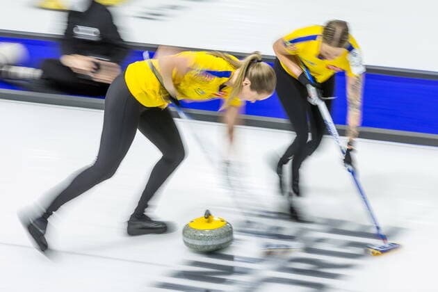 March 23, 2022, Prince George, BC, Canada: Sweden third Sara McManus, left, and lead Sofia Mabergs sweep in front of a stone against Canada at the Women s World Curling Championship in Prince George, B.C., on Wednesday, March 23, 2022. Canada News - March 23, 2022 - ZUMAc35_ 20220323_zaf_c35_097 Copyright: xJamesxDoylex