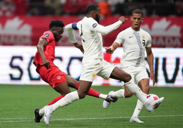 June 9, 2022, VANCOUVER, BC, CANADA: Canada s Alphonso Davies, left, takes a shot on goal past Curacao s Jurien Gaari (3) and Cuco Martina (2) during the first half of a CONCACAF Nations League soccer match, in Vancouver, on Thursday, June 9, 2022. Canada News - June 9, 2022 - ZUMAc35_ 20220609_zaf_c35_159 Copyright: xDarrylxDyckx