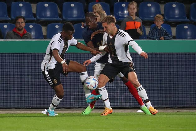 23.09.2022, xgox, Fussball U21, U 21 Laenderspiel, Deutschland - Frankreich emspor, v.l. Youssoufa Moukoko (Deutschland, 11), Castello Lukeba (Frankreich, 14), Kilian Fischer (Deutschland, 2) Zweikampf, Duell, Kampf, tackle (DFL DFB REGULATIONS PROHIBIT ANY USE OF PHOTOGRAPHS as IMAGE SEQUENCES and or QUASI-VIDEO) Magdeburg