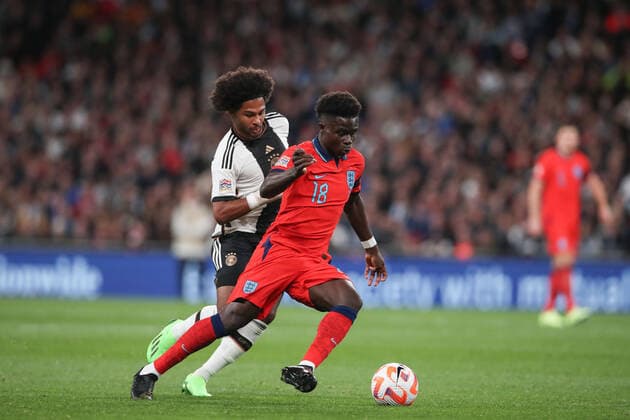 Mandatory Credit: Photo by Matt Impey Shutterstock (13422173aj) Bukayo Saka of England gets away from Serge Gnabry of Germany to set up the 2nd goal for England England v Germany, Football, UEFA Nations Cup, Wembley Stadium, Wembley, London, UK - 26 09 2022 Editorial use only England v Germany, Football, UEFA Nations Cup, Wembley Stadium, Wembley, London, UK - 26 09 2022 Editorial use only Copyright: xMattxImpey Shutterstockx 13422173aj