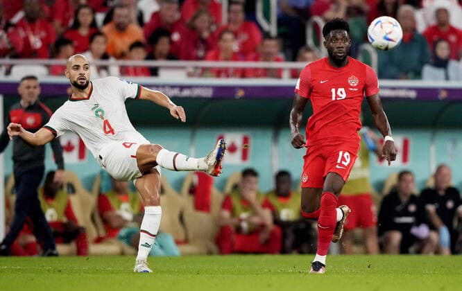 Mandatory Credit: Photo by Dave Shopland Shutterstock (13640369bo) Sofyan Amrabat of Morocco and Alphonso Davies of Canada. Canada v Morocco, FIFA World Cup, WM, Weltmeisterschaft, Fussball 2022, Group F, Football, Al Thumama Stadium, Doha, Qatar - 01 Dec 2022 Editorial Use Only Canada v Morocco, FIFA World Cup 2022, Group F, Football, Al Thumama Stadium, Doha, Qatar - 01 Dec 2022 Editorial Use Only Copyright: xDavexShopland Shutterstockx 13640369bo
