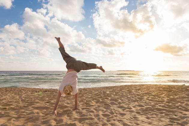 Free Happy Woman Turning Cartwheel Enjoying Sunset on Sandy Beach. Relaxed woman enjoying sun, freedom and life turning cartwheel on beautiful beach in sunset. Young lady feeling free, relaxed and happy. Vacations, freedom, happiness, enjoyment and well being. (License=RF) 10732359 Copyright: xZoonar.com MatejxKastelicx 10732359 ,model released, Symbolfoto ,property released
