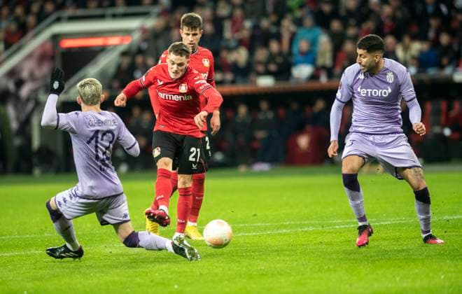 16.02.2023, GER, Fußball, Herren, UEFA, Fußball Europa League, Play-off, Saison 2022 2023, TSV Bayer 04 Leverkusen - AS Monaco Florian Wirtz (TSV Bayer 04 Leverkusen, Mitte) schießt zum 2:1 ein. Caio Henrique (AS Monaco, li.) und Guillermo Maripan (AS Monaco, re.) Leverkusen BayArena Nordrhein-Westfalen Deutschland