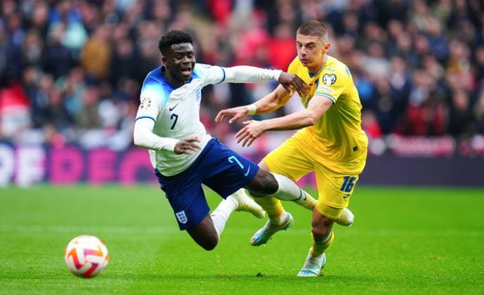 Mandatory Credit: Photo by Javier Garcia Shutterstock (13840577gu) Vitaliy Mykolenko of Ukraine fouls Bukayo Saka of England England v Ukraine, UEFA European Championship, EM, Europameisterschaft 2024 Qualifying, Group C, Football, Wembley Stadium, London, UK - 26 Mar 2023 EDITORIAL USE ONLY No use with unauthorised audio, video, data, fixture lists, club league logos or live services. Online in-match use limited to 120 images, no video emulation. No use in betting, games or single club league player publications. England v Ukraine, UEFA European Championship 2024 Qualifying, Group C, Football, Wembley Stadium, London, UK - 26 Mar 2023 EDITORIAL USE ONLY No use with unauthorised audio, video, data, fixture lists, club league logos or live services. Online in-match use limited to 120 images, no video emulation. No use in betting, games or single club league player publications. Copyright: xJavierxGarcia Shutterstockx 13840577gu