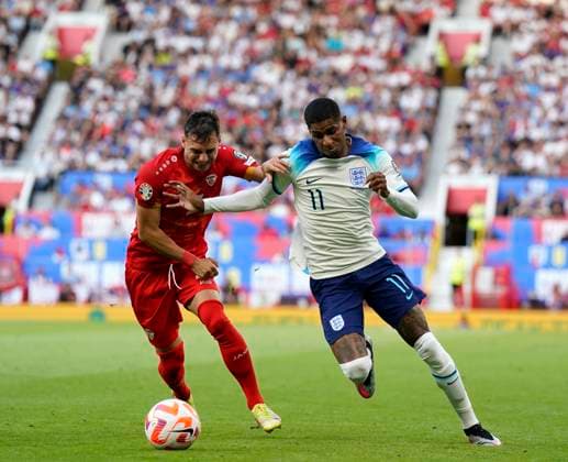 Manchester, England, 19th June 2023. Marcus Rashford of England with Stefan Ashkovski of North Macedonia during the UEFA European Championship, EM, Europameisterschaft Qualifying match at Old Trafford, Manchester. Picture credit should read: Andrew Yates Sportimage EDITORIAL USE ONLY. No use with unauthorised audio, video, data, fixture lists, club league logos or live services. Online in-match use limited to 120 images, no video emulation. No use in betting, games or single club league player publications. SPI-2485-0042